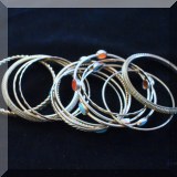 J09. Silvertone bangle bracelets. 
